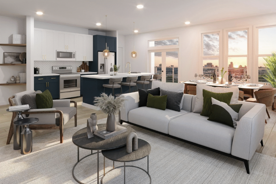 Modern open-concept living room and kitchen featuring white and navy cabinets and large windows.